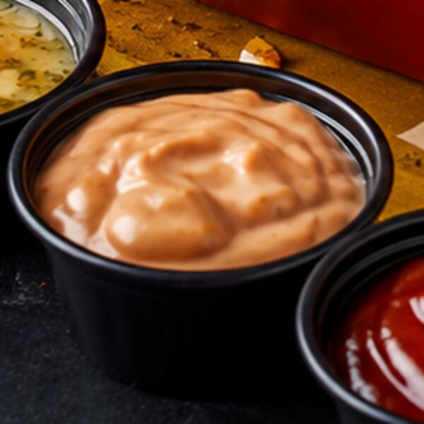Close-up of a cup of creamy pink sauce